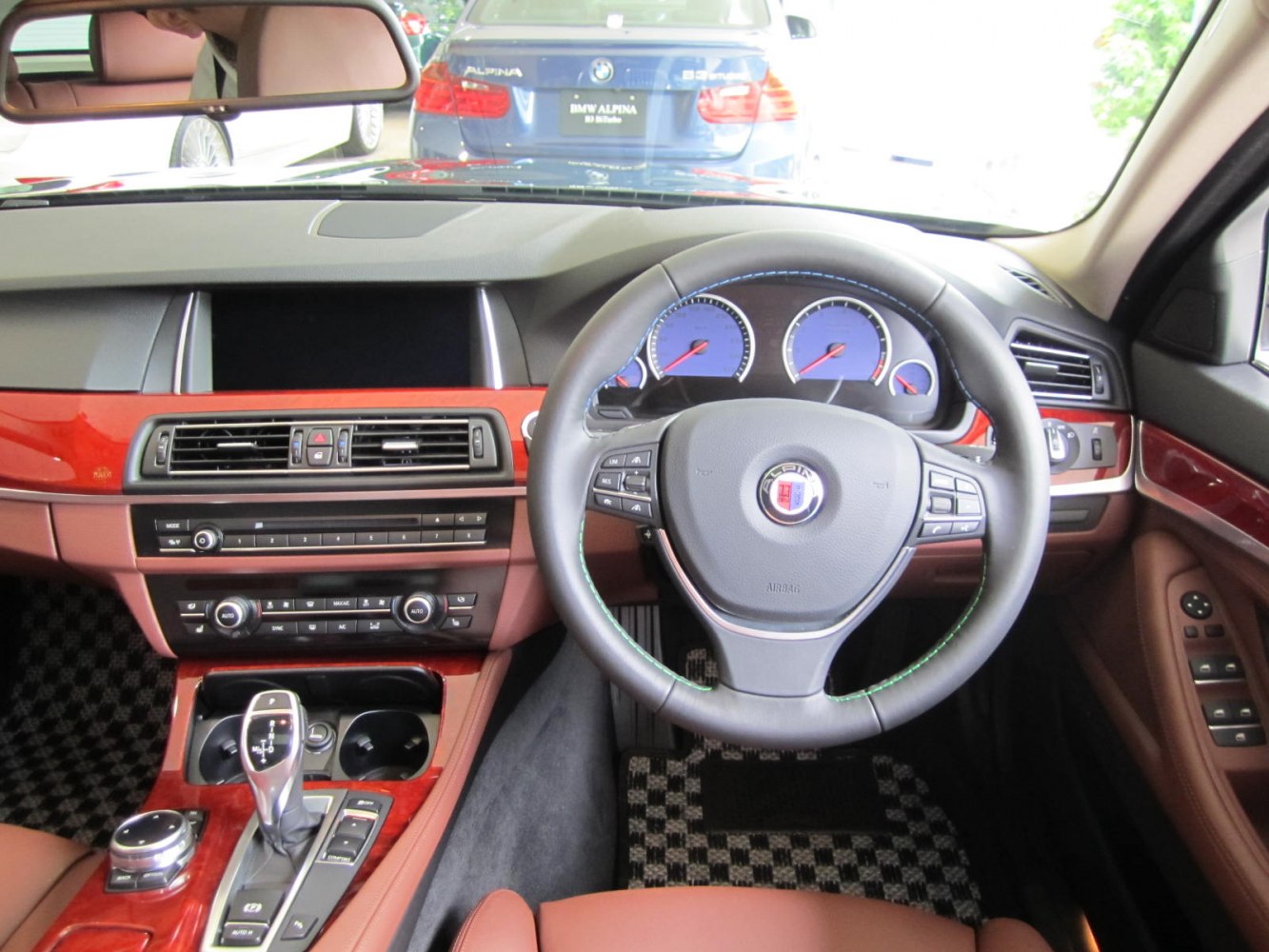 Luxury dashboard and steering wheel with wood trim and modern controls