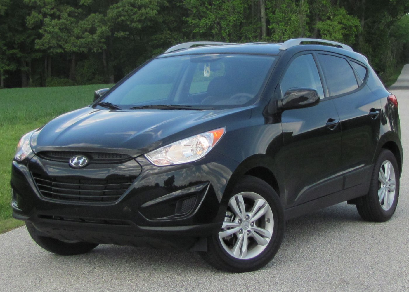 Front-side view of black SUV with alloy wheels and sleek headlights