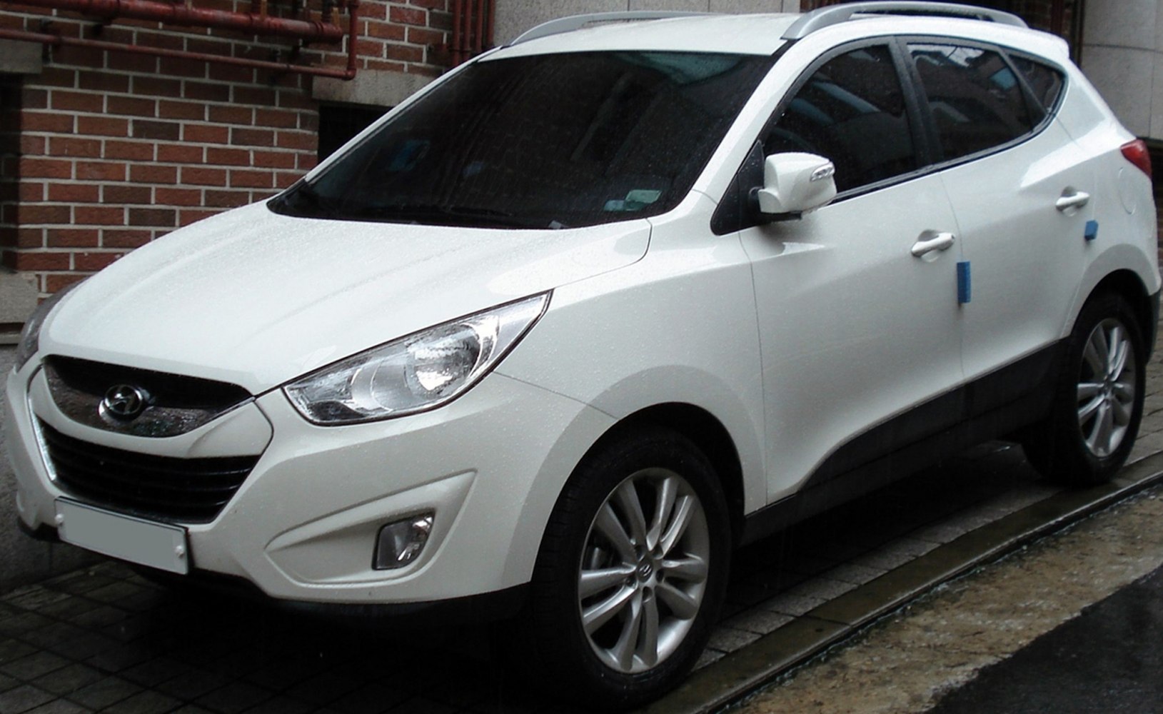 White compact SUV front side with alloy wheels and headlights