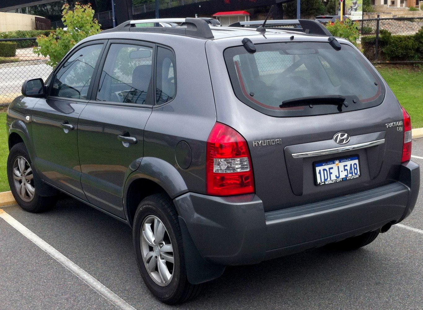 Rear and side exterior view of compact SUV with roof rails and alloy wheels