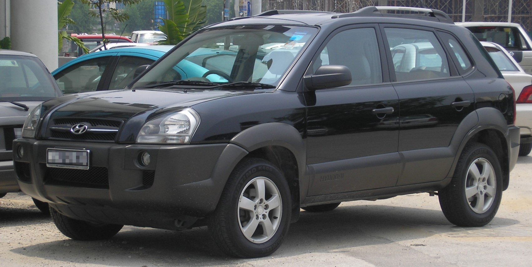 Black SUV front side view with roof rails and alloy wheels