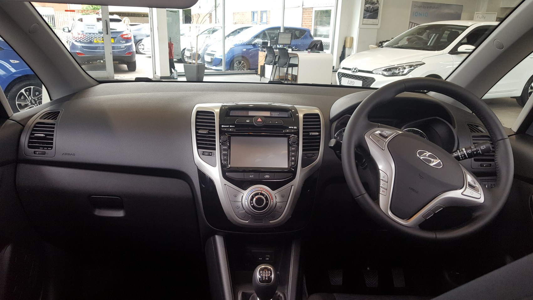 Dashboard with central infotainment and multifunction steering wheel