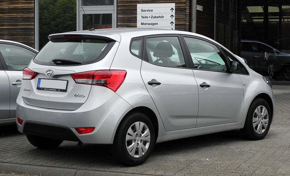 Rear side view of compact five-door hatchback with prominent taillights and silver finish