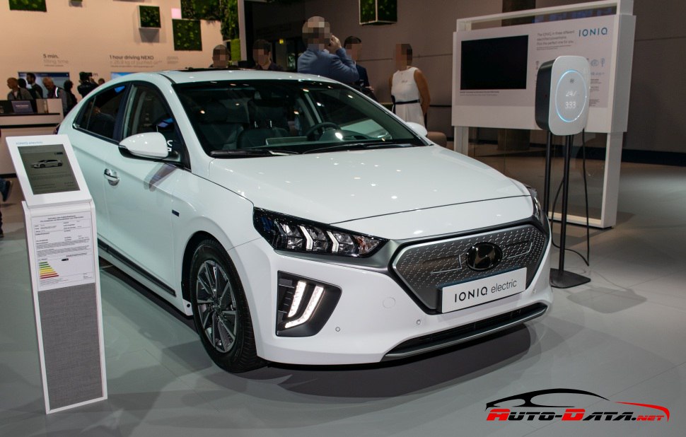 White electric sedan front view with distinctive grille and LED headlights