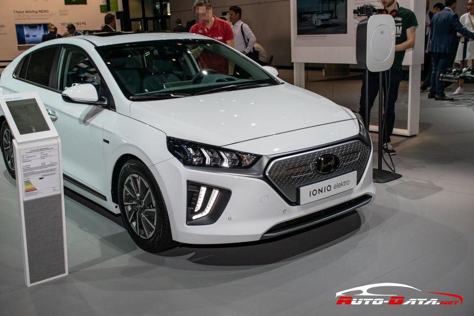 Front and side view of white electric vehicle with LED headlights and detailed grille design.