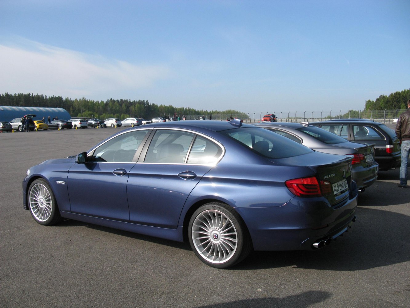 Rear side profile with multi-spoke wheels and quad exhaust tips