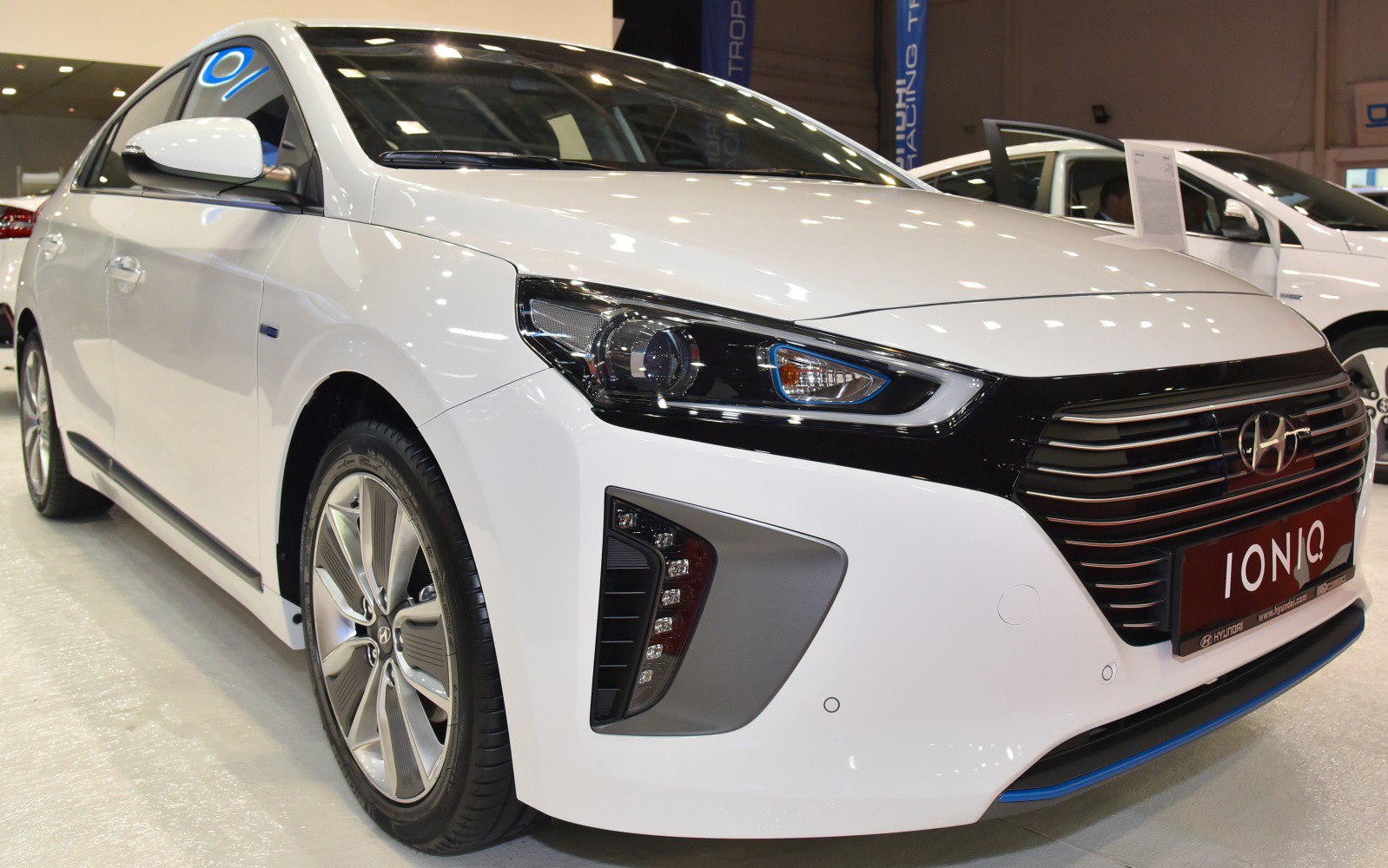 Close-up of front grille and sleek headlights with sporty bumper detail