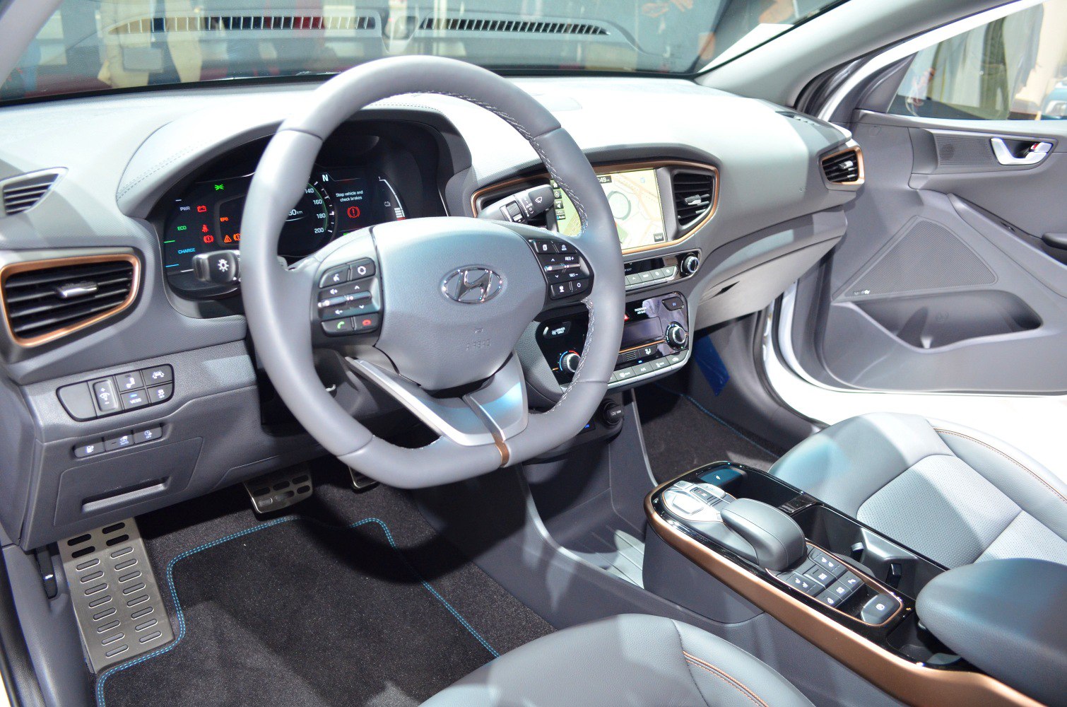 Modern car interior with a multifunction steering wheel and digital dashboard display.