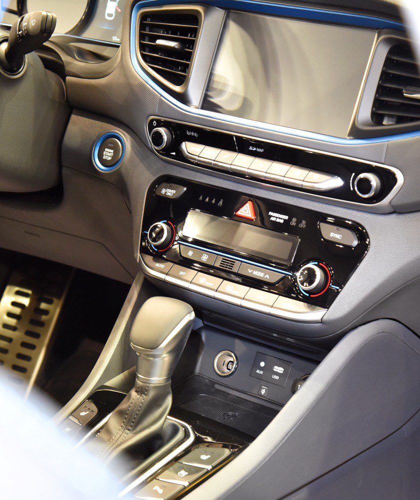 Interior console with gear shift, climate controls, and multimedia panel