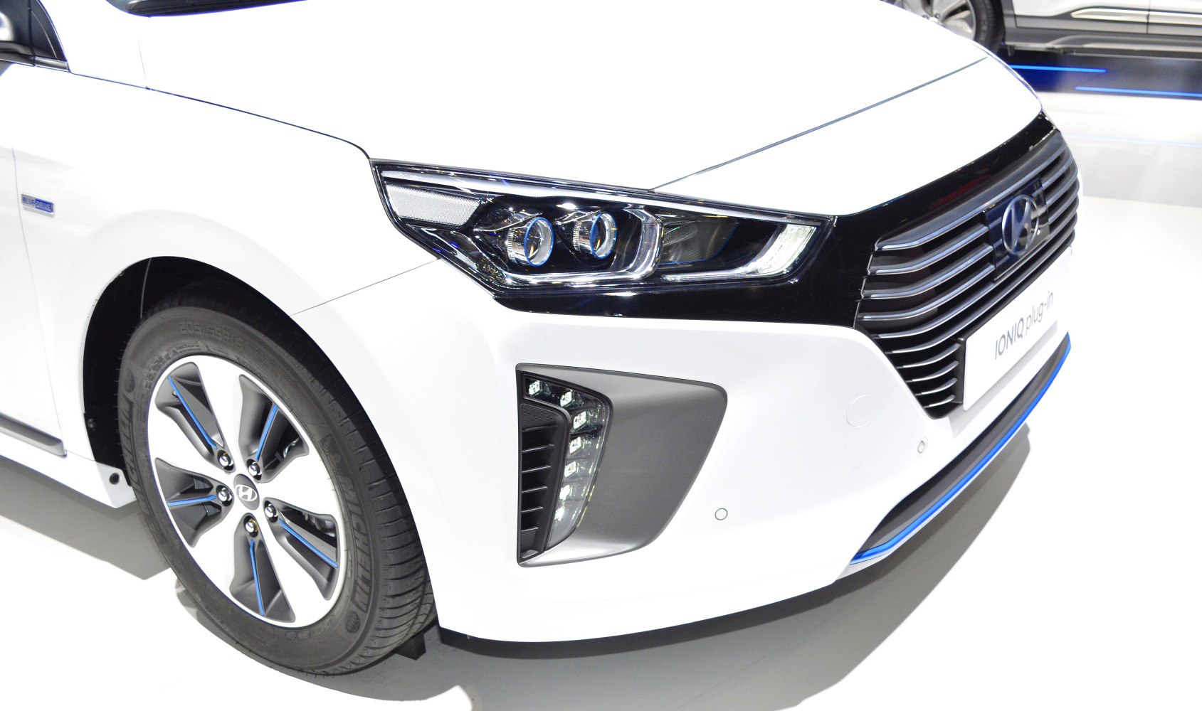Close-up of modern front headlight and aerodynamic wheel design
