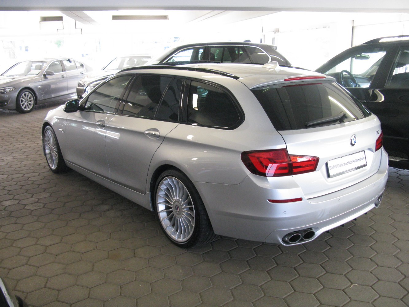 Silver station wagon rear-side view with quad exhaust and alloy wheels