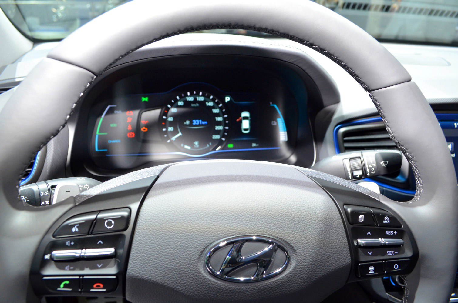 Steering wheel with control buttons and digital dashboard with speedometer