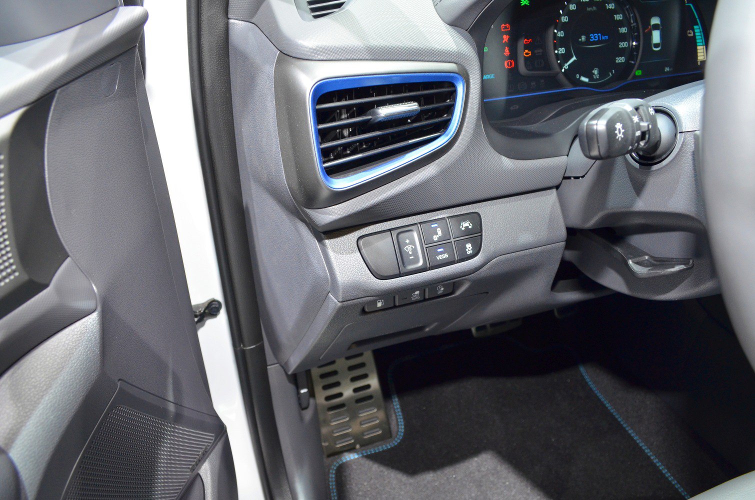Dashboard air vent and driver control buttons with instrument cluster.
