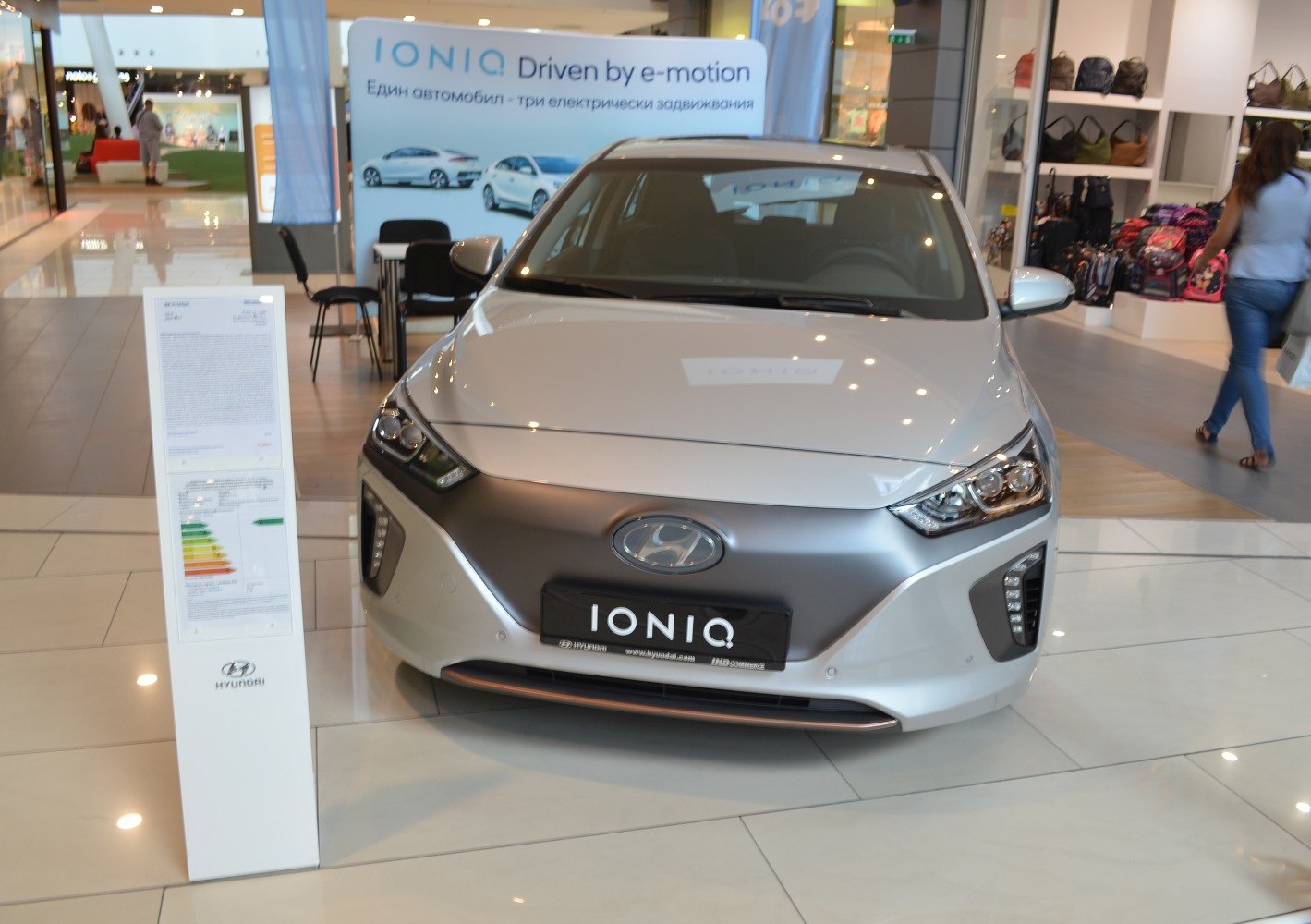 Front view of a hybrid and electric vehicle with LED headlights and closed grille.
