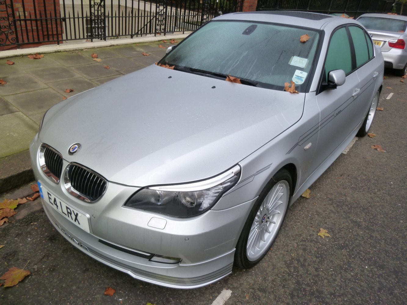 Silver sporty sedan with multi-spoke wheels and striped body accents