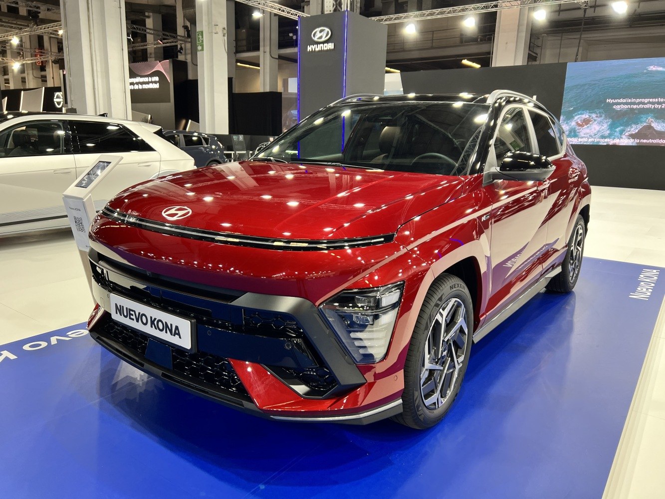 Front view of a red SUV with sleek LED headlights and bold grille