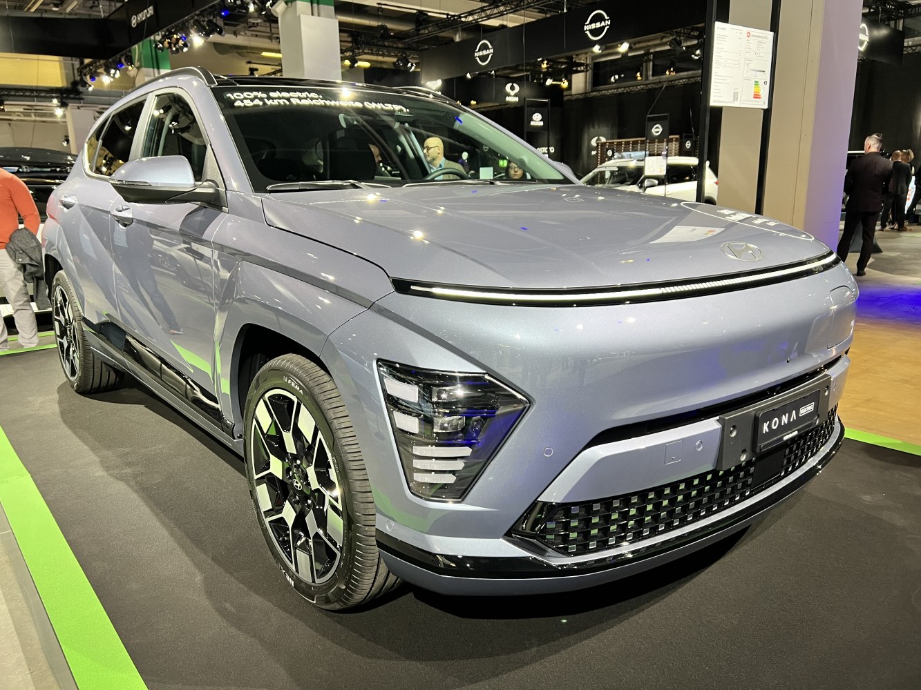 Futuristic LED headlights and sleek front grille on a modern electric SUV