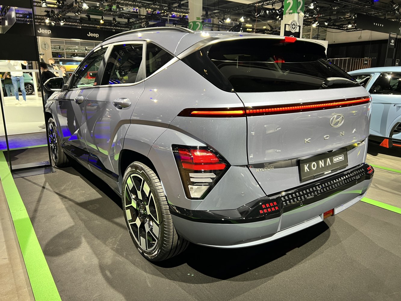 Modern rear view of electric SUV with sleek LED light strip.