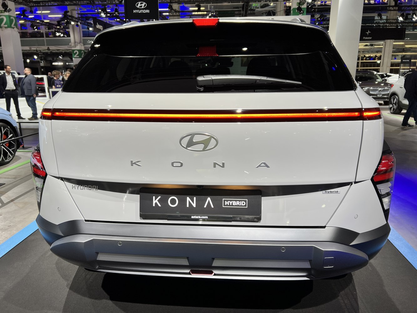 Rear view with full-width LED light bar and hybrid badge.