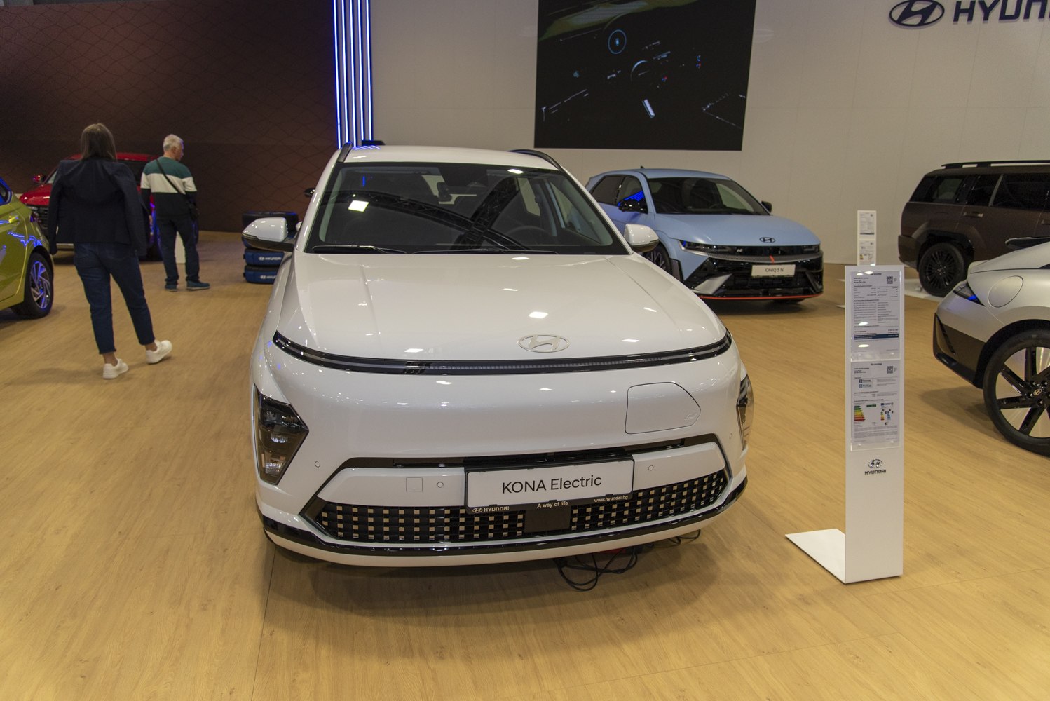 Front view of electric SUV with distinctive light strip and modern grille pattern