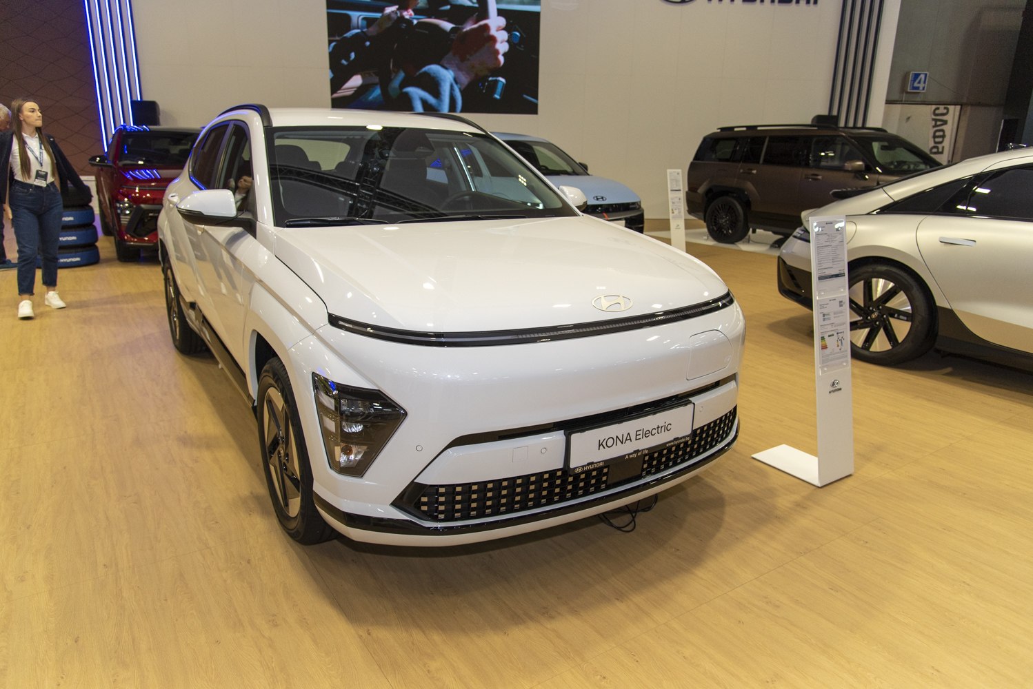 Front view of electric SUV with LED headlights and sleek grille.