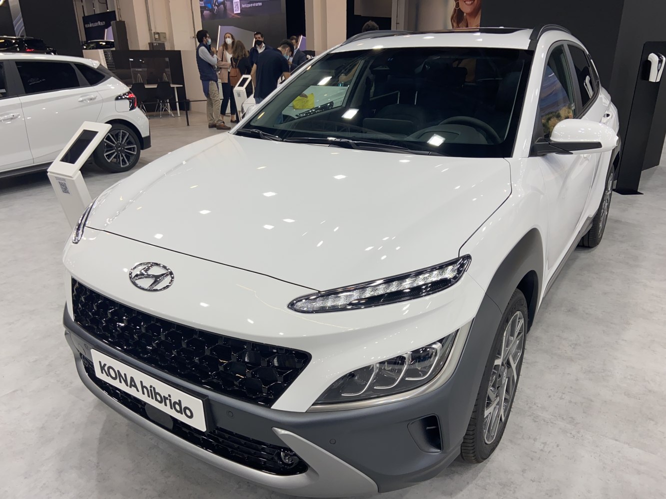 Sleek front grille with LED daytime running lights on white hybrid SUV