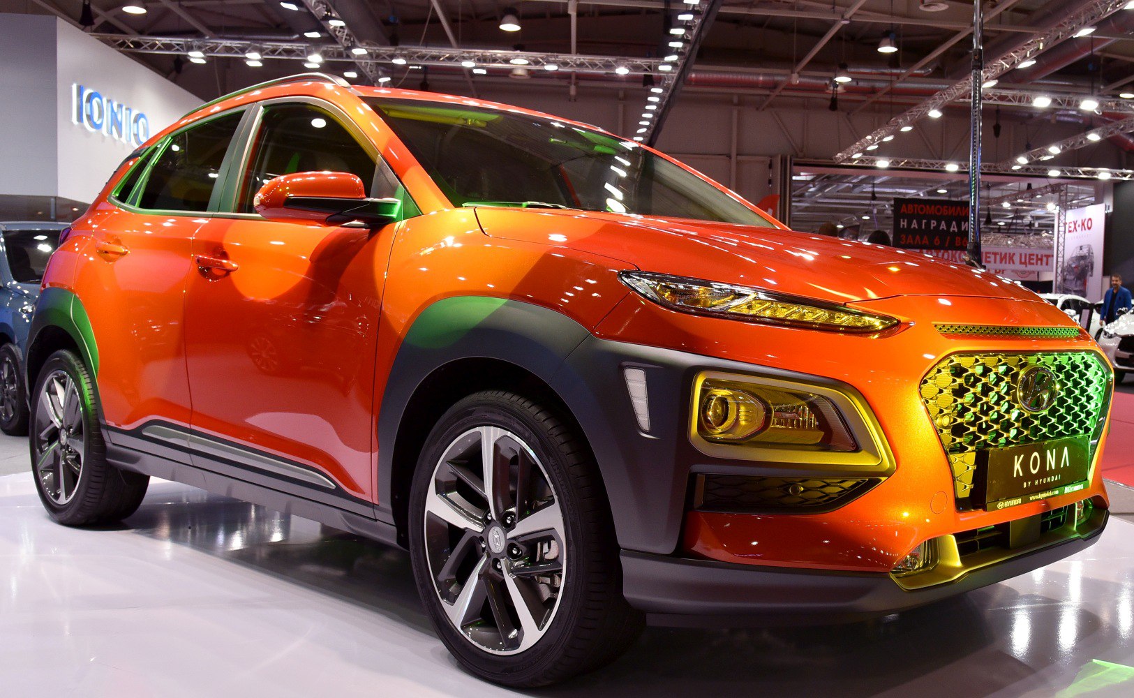 Front angle of bright orange SUV with split LED headlights and alloy wheels