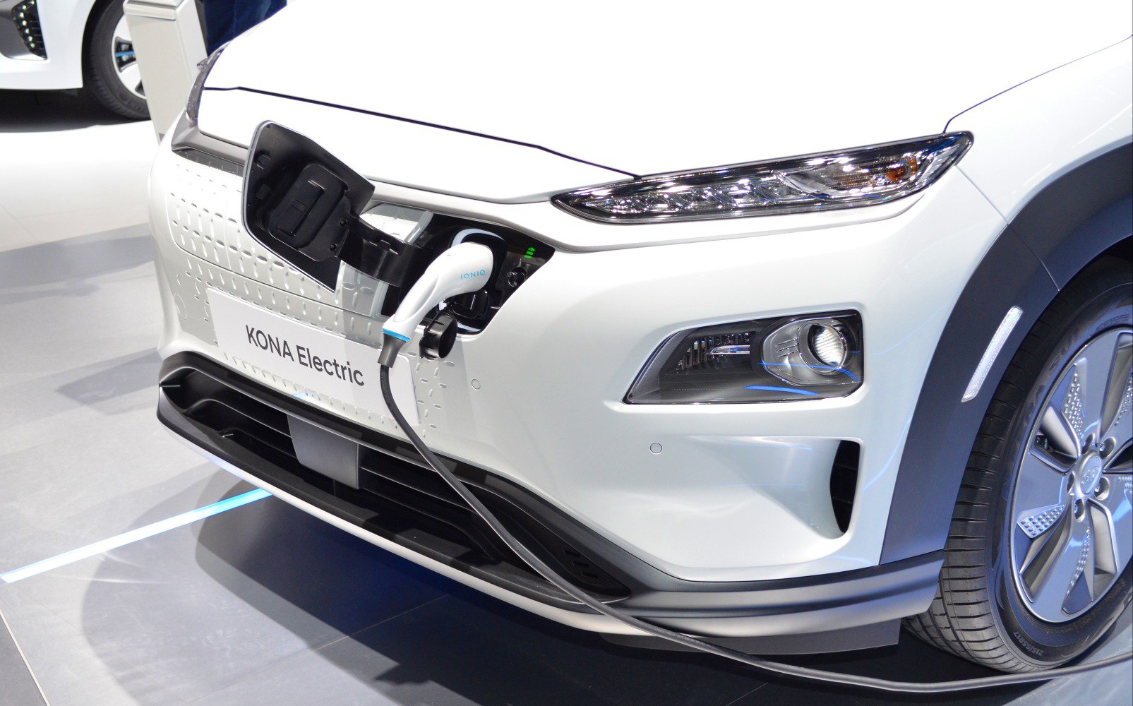 Electric vehicle front with charging plug and LED headlights