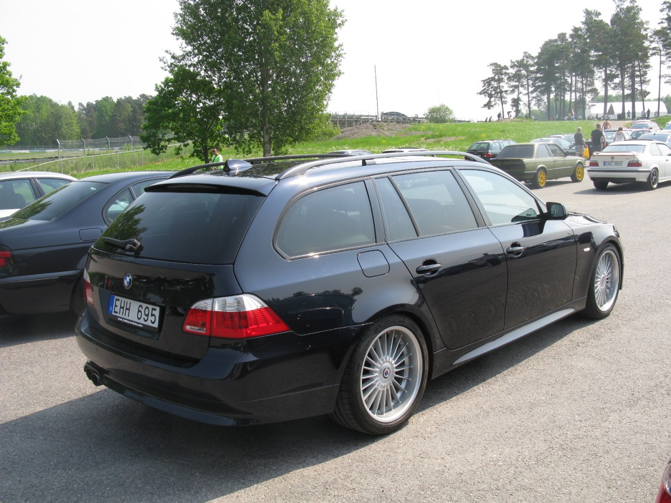 Rear view of a performance wagon with alloy wheels and dual exhaust