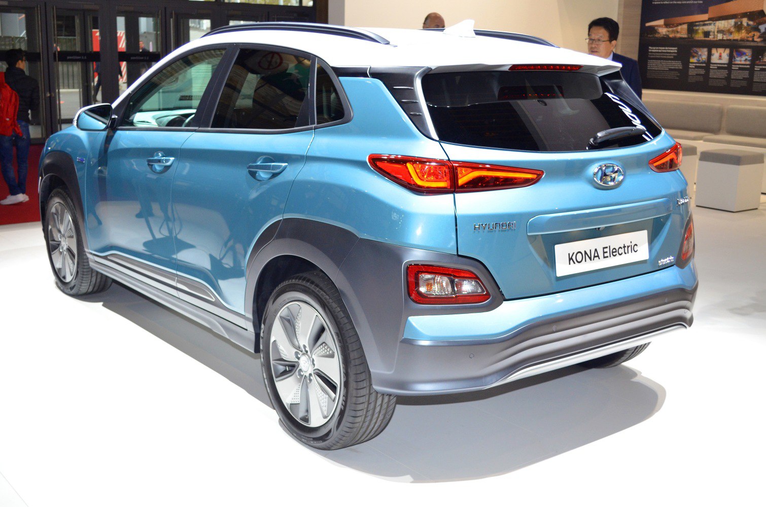 Rear and side view of a blue electric crossover with distinct taillights and aerodynamic features