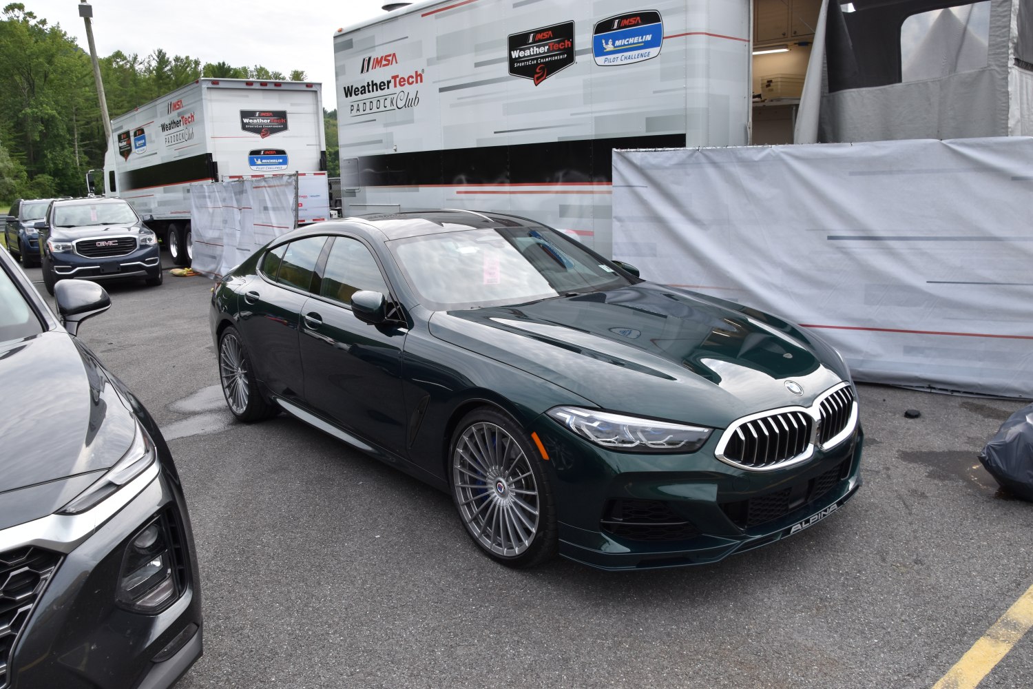 Front view of a luxury sedan with signature grille and multi-spoke wheels