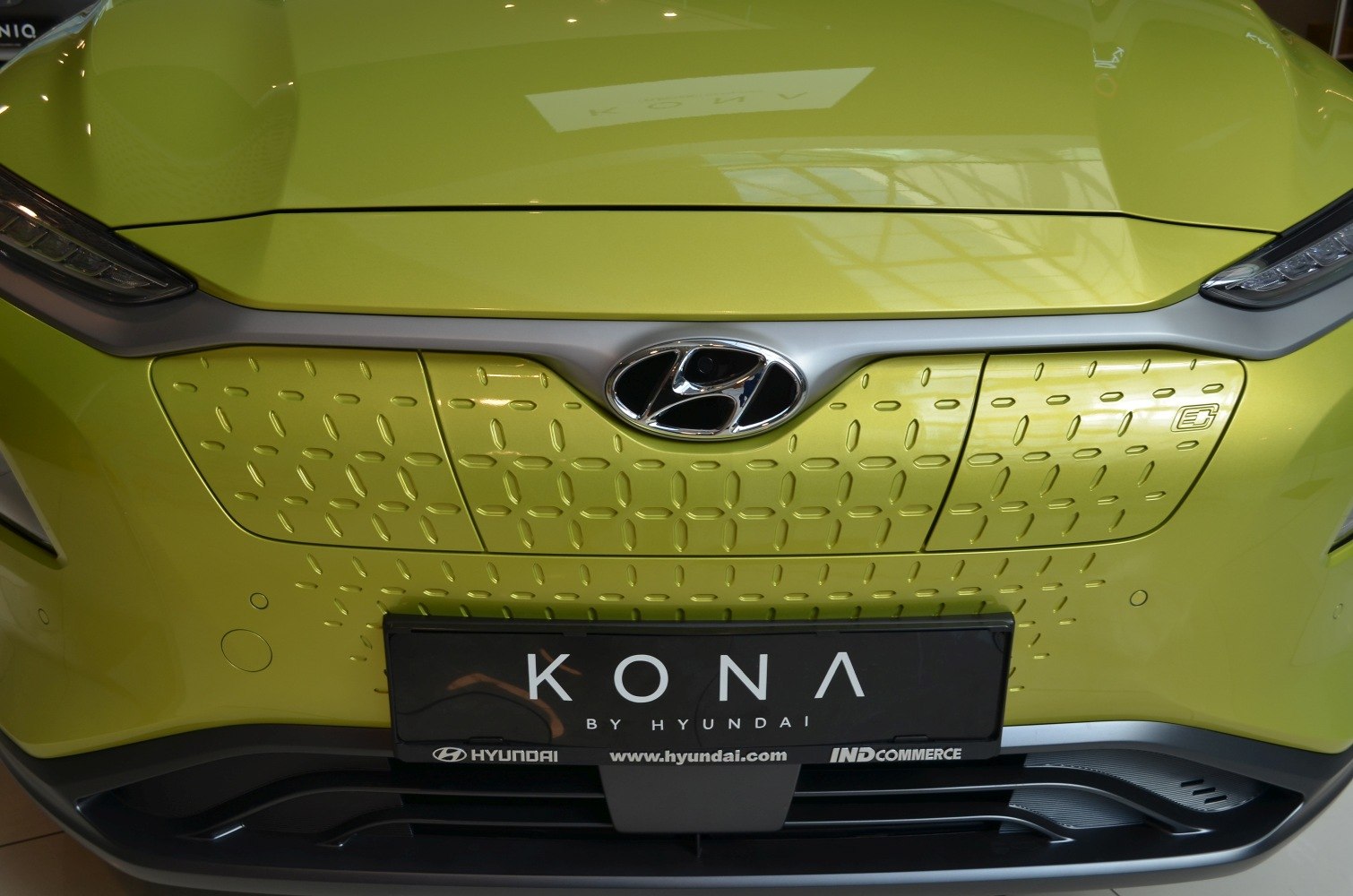 Close-up of front grille and Hyundai emblem on lime green exterior