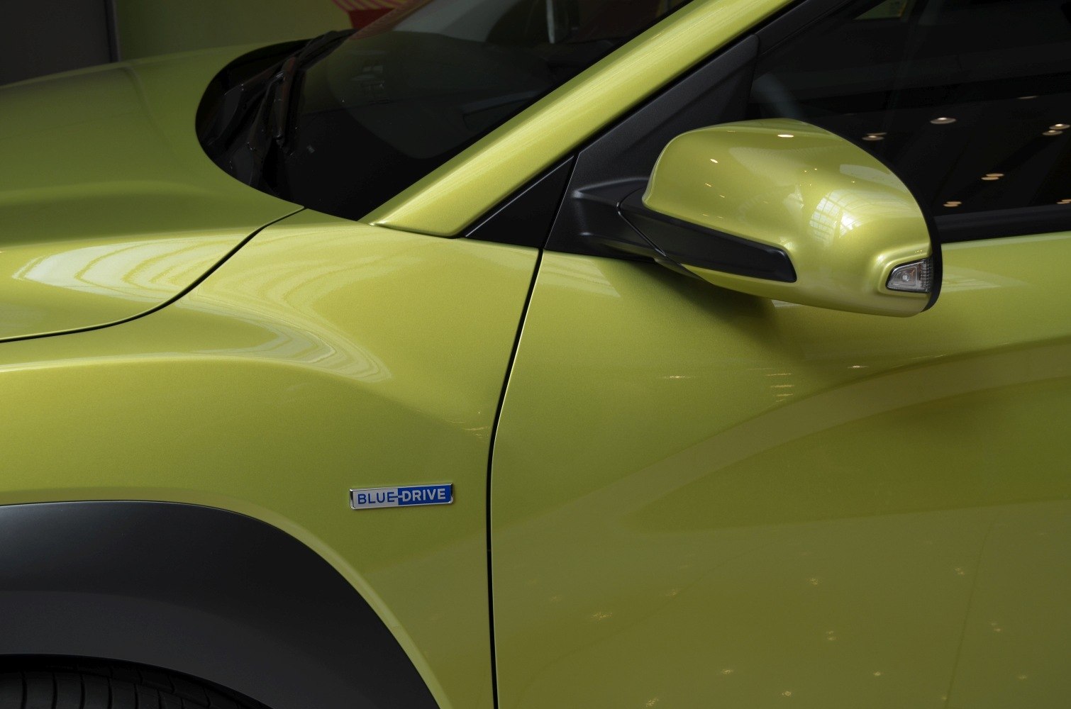 Close-up of Blue Drive badge and side mirror on car exterior