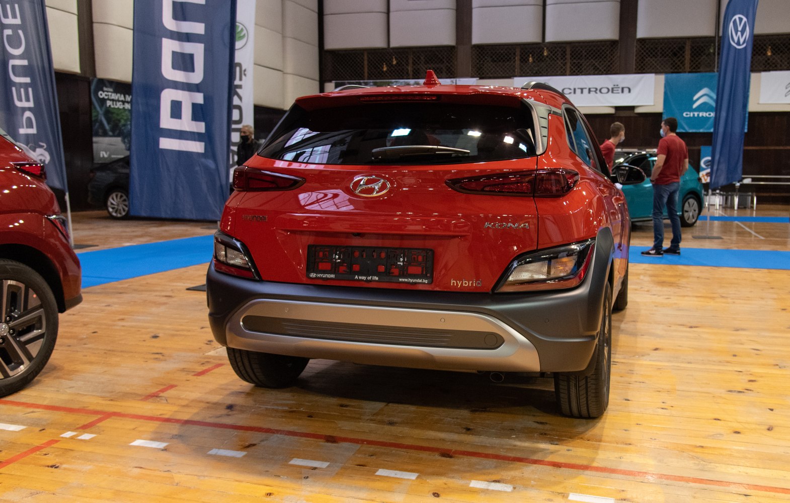 Red compact SUV rear with hybrid badge and sleek taillights