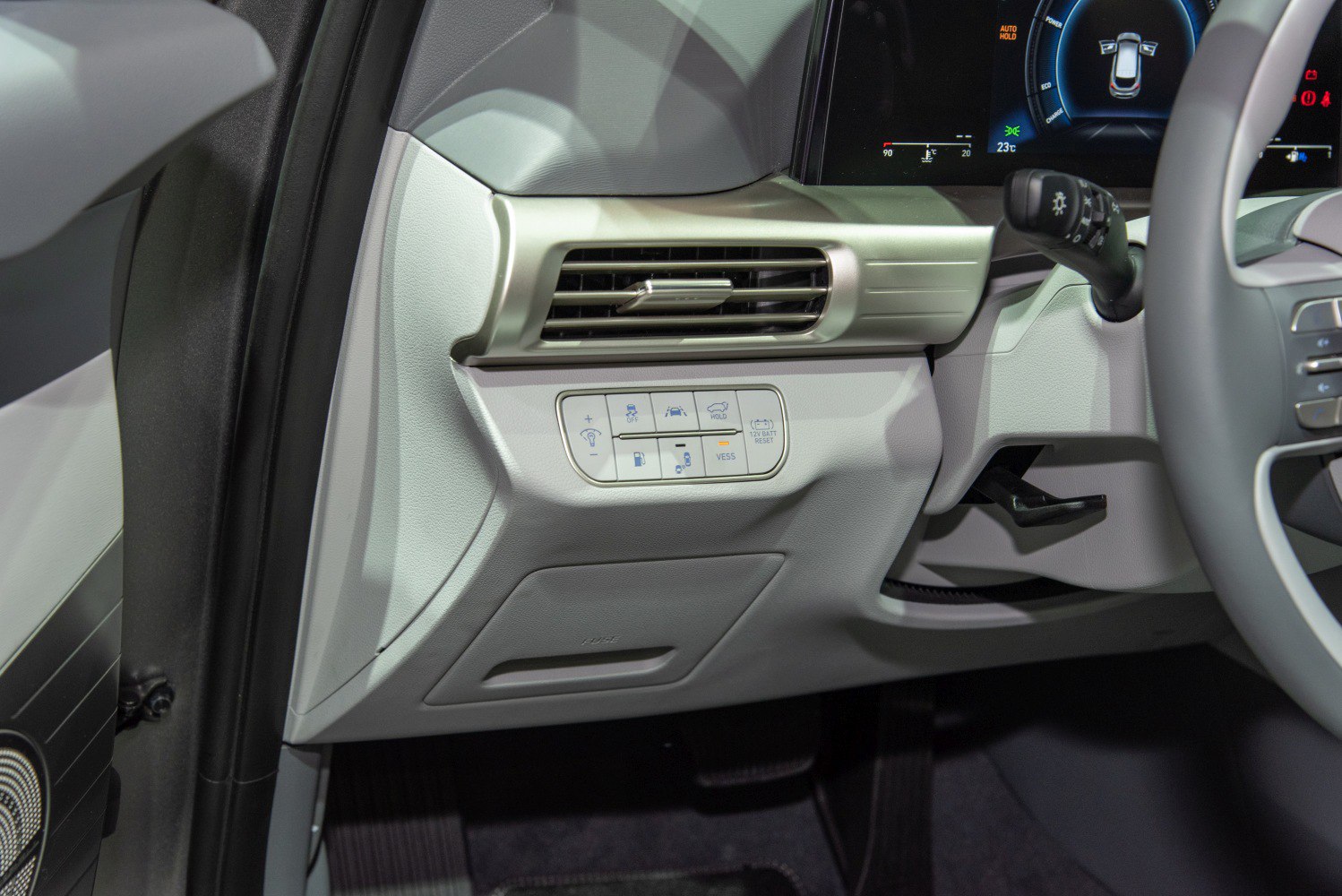 Car interior air vent and control buttons panel near steering wheel