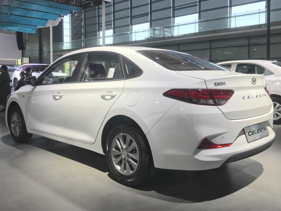 Side and rear view of white Hyundai sedan with distinctive taillights.