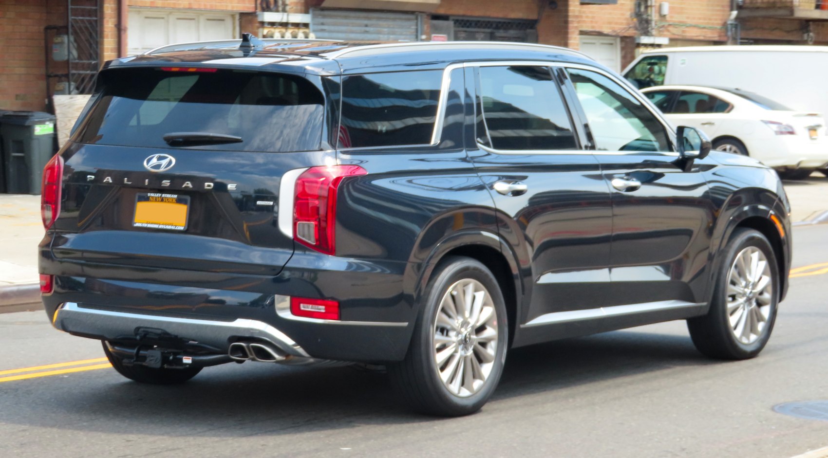 Rear and side view of a mid-size SUV with dual exhaust and vertical taillights