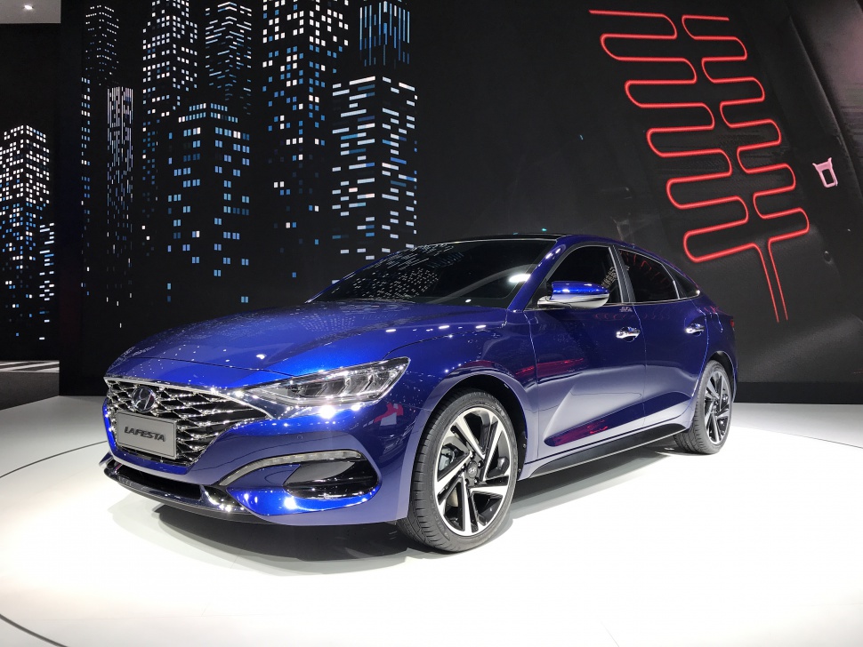 Front side view with alloy wheels and sleek blue exterior
