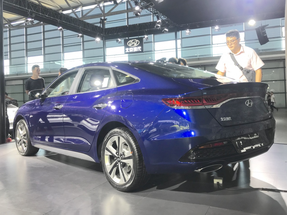 Sleek rear and side view with LED taillights and sculpted body lines.