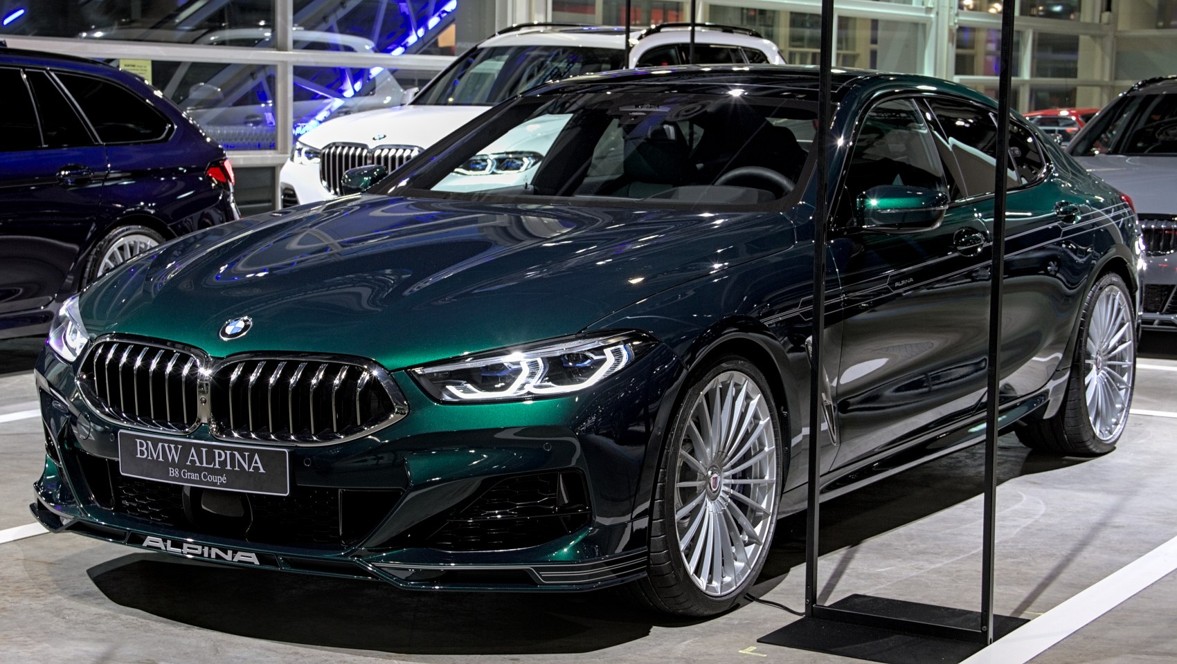Front and side view of luxury performance sedan with distinctive grille and multi-spoke wheels