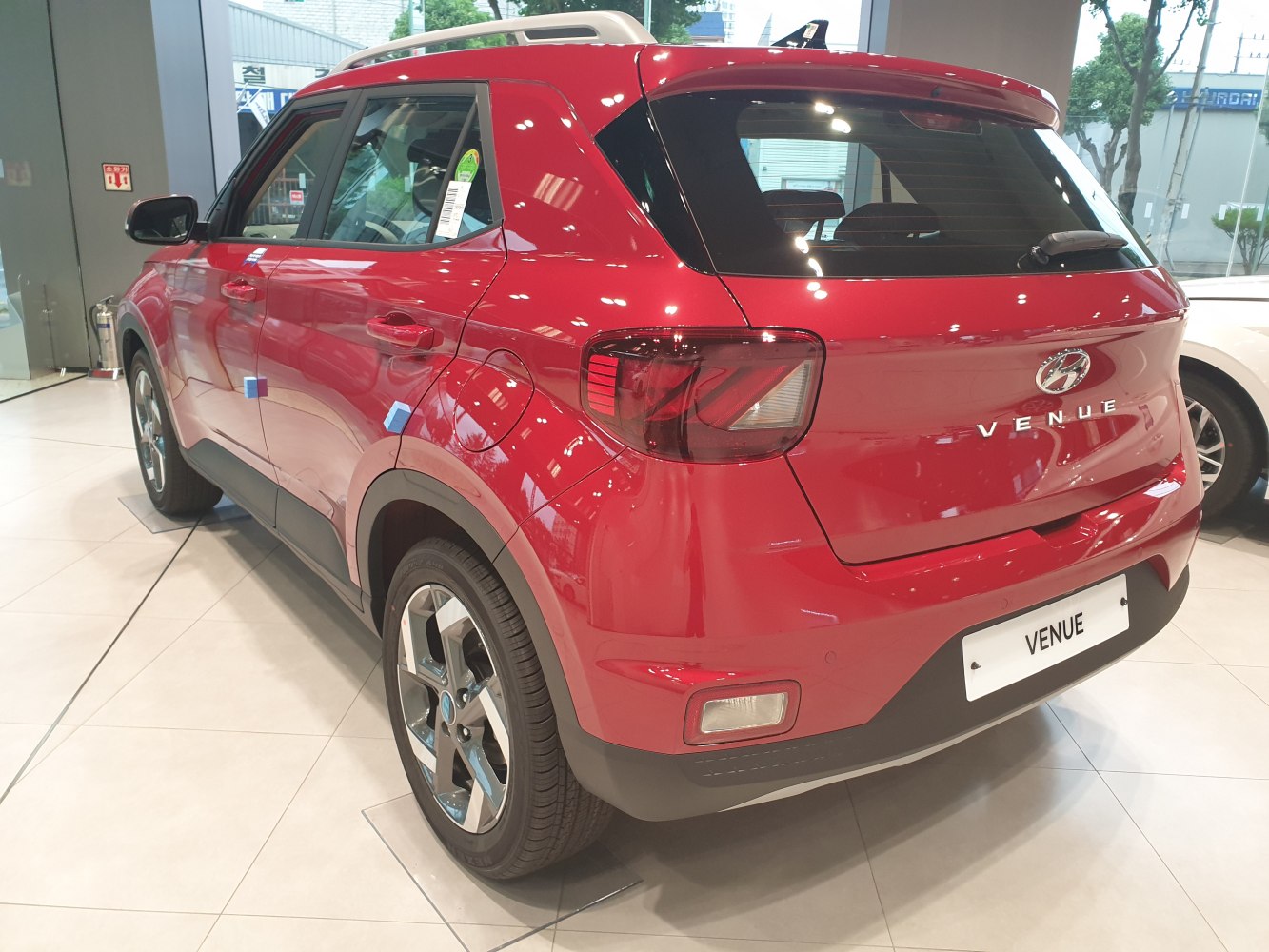 Rear three-quarter view of red subcompact SUV with distinct taillights and alloy wheels