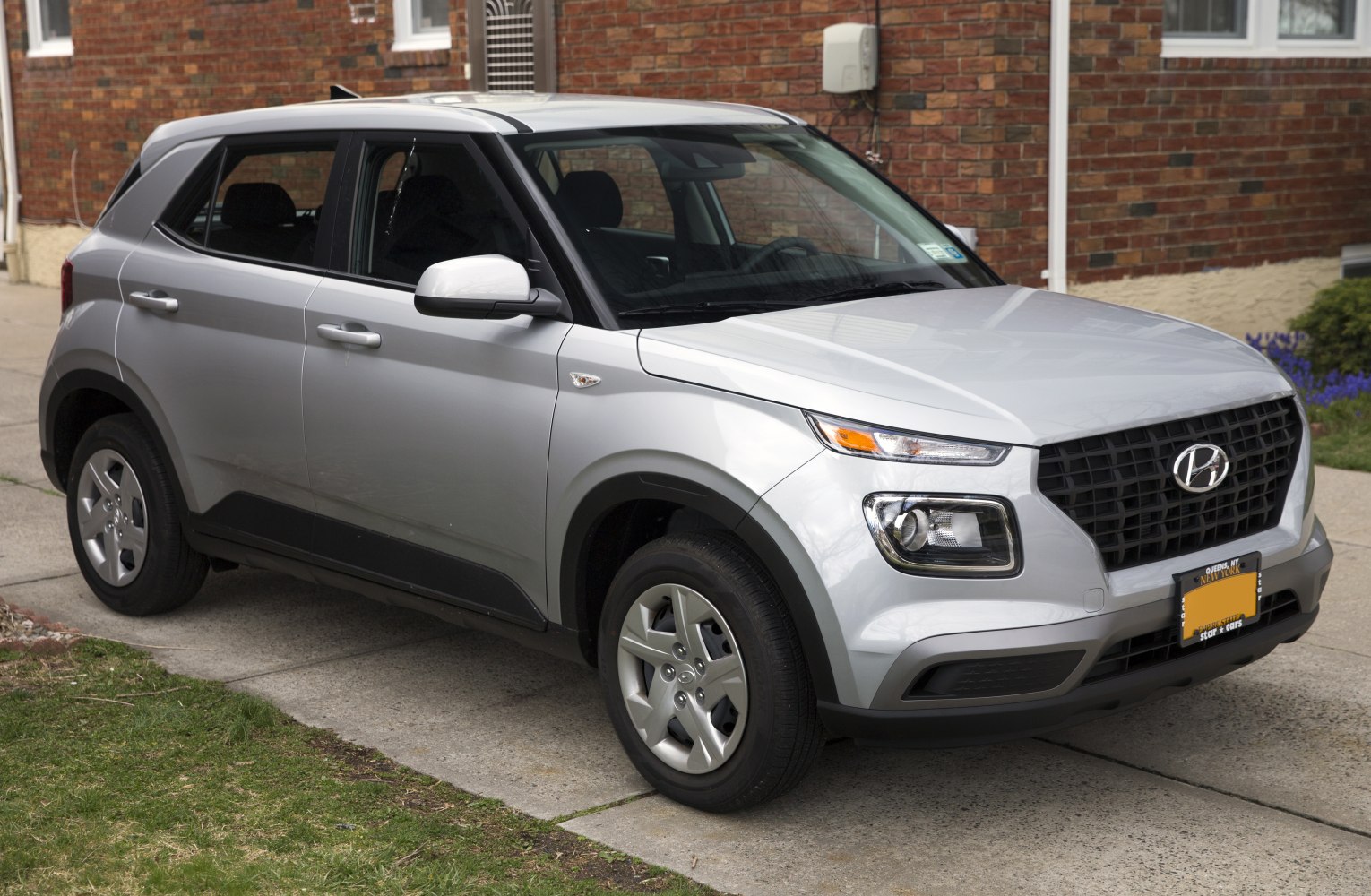 Silver compact SUV front side view with distinct headlights and grille