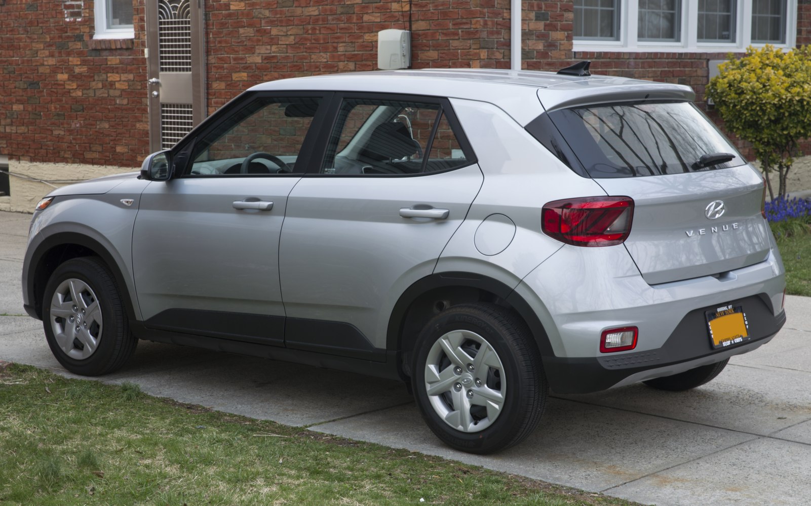 Silver compact SUV rear side with rugged wheel arches and taillights