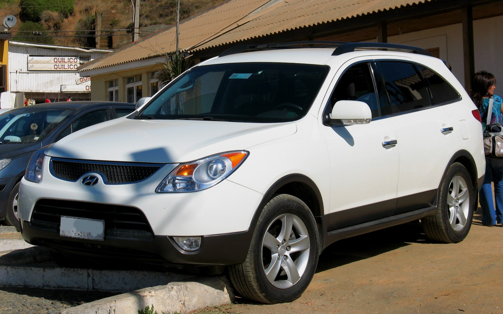 White SUV front-side view with distinct headlights and alloy wheels