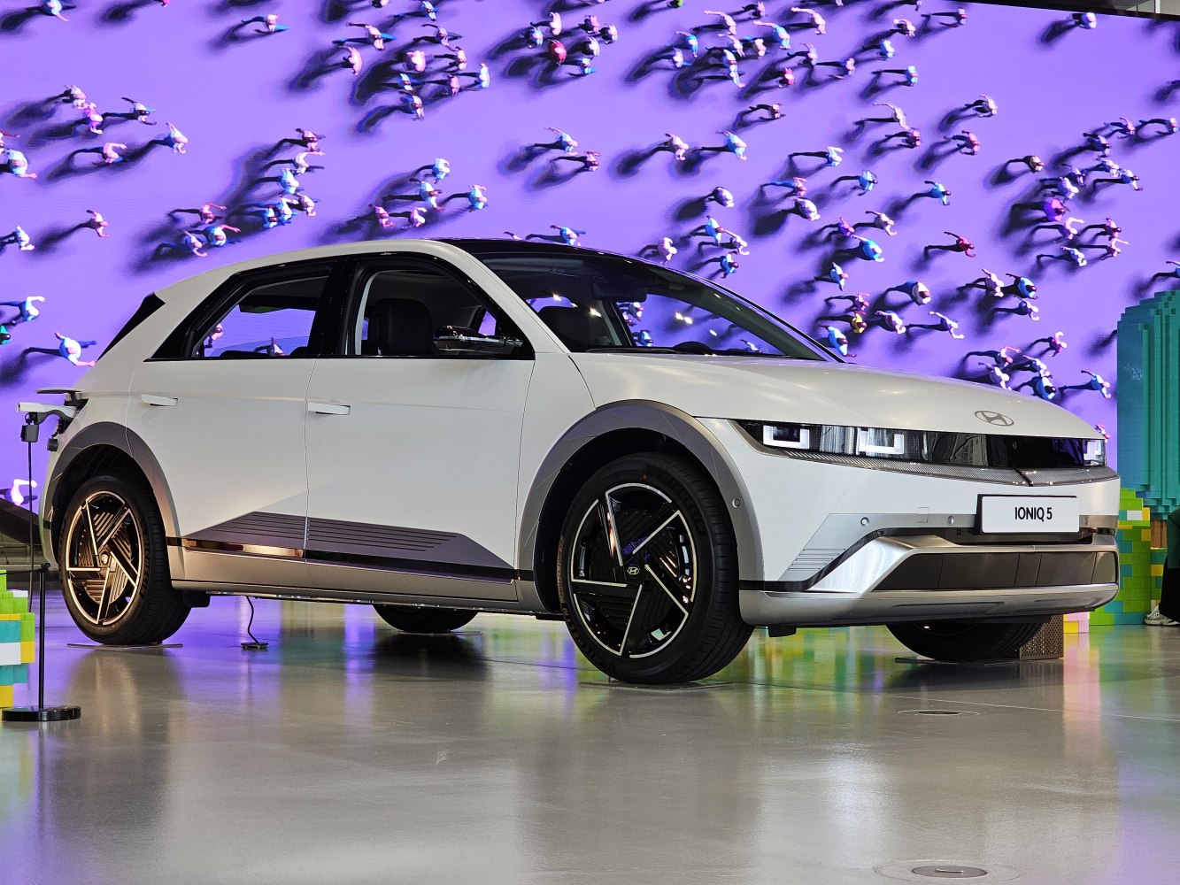 Sleek modern electric vehicle with LED headlights and aerodynamic wheels