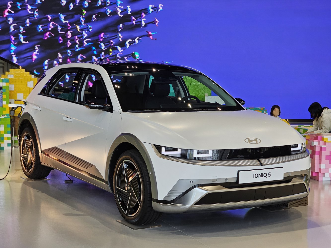 Front-side view of facelifted electric SUV with angular headlights and aerodynamic wheels