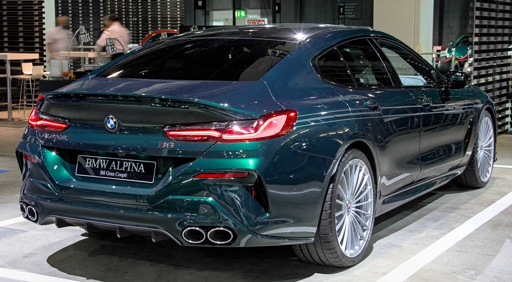 Rear view of luxury sedan with quad exhaust and sleek design