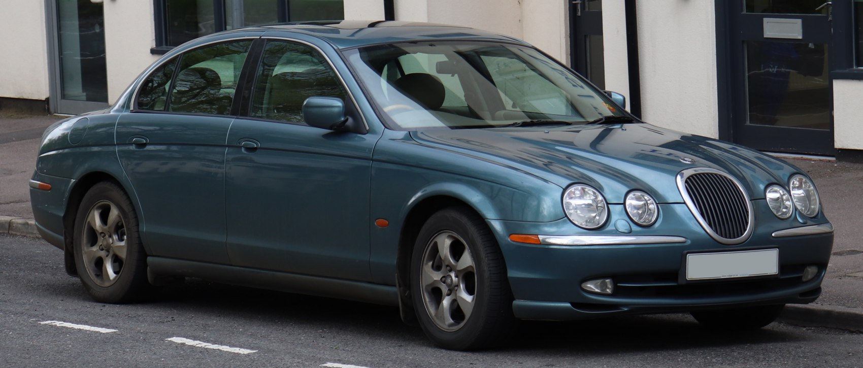 Front-side view with quad headlights on sleek sedan body