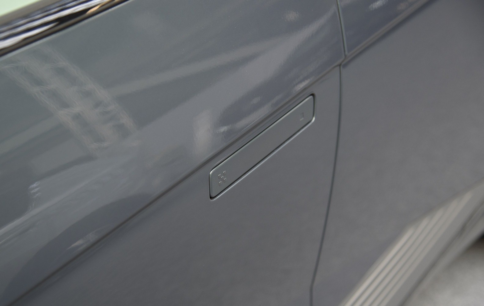 Close-up of flush hidden door handle on EV