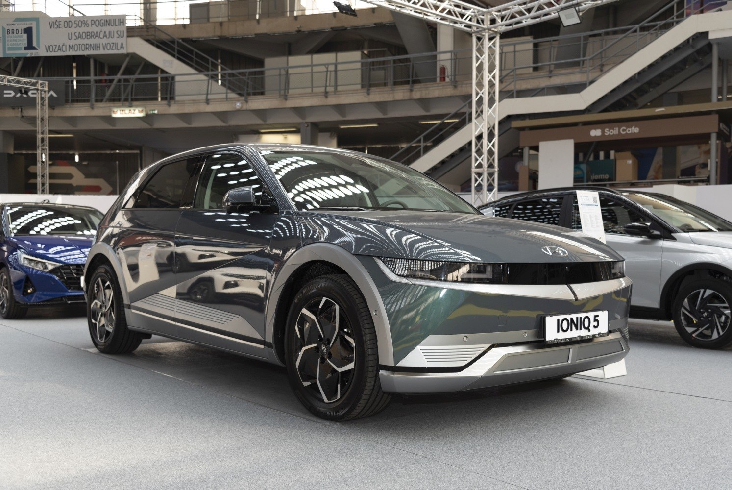 Futuristic front angle view of an electric crossover with LED headlights and modern alloy wheels.